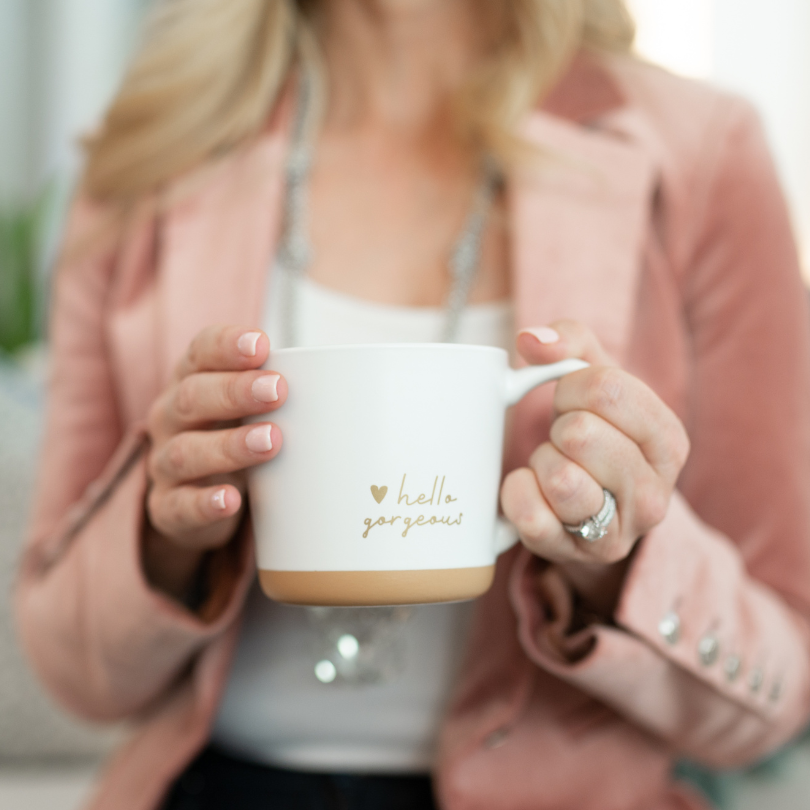 Close-up of hands holding a coffee mug